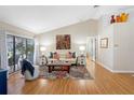 Bright living room with vaulted ceilings, hardwood floors, and stylish decor at 8640 Chadwick Dr, Tampa, FL 33635