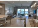 Open-concept living room with a lake view, stylish furniture, and lots of natural light at 953 Crosswind Ave, Sarasota, FL 34240