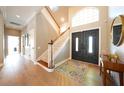 Bright foyer with hardwood floors, staircase, and double doors, showcasing a welcoming entrance at 12117 Clear Harbor Dr, Tampa, FL 33626