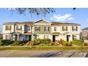 Exterior view of townhomes with landscaping and designated parking at 14925 Promenade Pkwy, Odessa, FL 33556