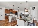 Modern kitchen with granite counters, breakfast bar, and an open-concept dining area at 14925 Promenade Pkwy, Odessa, FL 33556