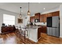 Updated kitchen featuring granite countertops, stainless steel appliances, and a breakfast bar at 14925 Promenade Pkwy, Odessa, FL 33556