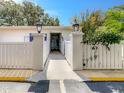Inviting walkway with decorative fence leading to unit entrance at 1655 S Highland Ave # G164, Clearwater, FL 33756