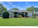 Inviting home exterior featuring lush lawn and colorful flowerbeds, enhance curb appeal at 22240 Stillwood Dr, Land O Lakes, FL 34639