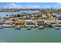 A stunning aerial shot of waterfront homes with private docks on a calm bay, showcasing neighborhood charm at 330 176Th Avenue Cir, Redington Shores, FL 33708