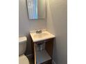 A compact bathroom features a single vanity with open storage, complemented by neutral walls and standard toilet at 3718 19Th S Ave, St Petersburg, FL 33711