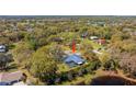 Aerial view of property with a screened-in pool and spacious yard at 37350 Neighbors Path, Zephyrhills, FL 33542