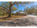 Inviting single-story home with mature landscaping and a long driveway at 37350 Neighbors Path, Zephyrhills, FL 33542
