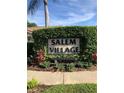 The community sign for Salem Village surrounded by lush, mature greenery at 3798 Darston St, Palm Harbor, FL 34685