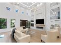 Stunning living room with soaring ceilings, fireplace, and large windows for ample natural light at 4308 W Beach Park Dr, Tampa, FL 33609