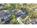 An aerial view of a home surrounded by mature trees and neatly maintained lawns in a residential neighborhood at 4624 W Lamb Ave, Tampa, FL 33629