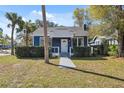 Attractive blue home with well-kept landscaping and a inviting front entrance at 502 W Hanna Ave, Tampa, FL 33604