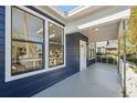 Inviting covered porch with views from the windows, blending indoor-outdoor living at 502 W Hanna Ave, Tampa, FL 33604