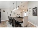 Formal dining room features a dark wood table, elegant chandelier, and decorative wall accents at 5441 Worthington Loop, Palm Harbor, FL 34685