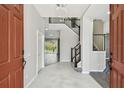 Elegant foyer with soaring ceilings, chandelier, and staircase leading to the second floor at 7309 Night Heron Dr, Land O Lakes, FL 34637