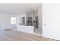 Spacious kitchen with modern cabinets and a large island awaiting finishing touches in an open-concept design at 8917 Calumet Blvd, Port Charlotte, FL 33981
