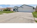 Spacious driveway leading to a home with a large two-car garage at 9826 La Vonda St, Riverview, FL 33569