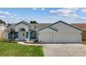 Beautiful single-story home with a two-car garage, featuring a well-kept lawn and pleasing curb appeal at 9826 La Vonda St, Riverview, FL 33569