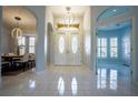 Bright foyer featuring large double doors with decorative glass and complemented by tile flooring at 10411 Cory Lake Dr, Tampa, FL 33647