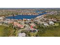 Beautiful aerial view of community home with tile roof near lake; great location and amenities at 10408 Double Bayou Way, Tampa, FL 33615