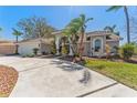 Charming single-story home with well-maintained landscaping, a tile roof, and an attached two-car garage at 10408 Double Bayou Way, Tampa, FL 33615