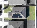 Top-down view of a home with solar panels and well-manicured lawns in a neighborhood at 1107 Brenton Leaf Dr, Ruskin, FL 33570