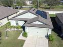 Beautiful single-story home with solar panels and a well-maintained lawn, offering energy efficiency at 1107 Brenton Leaf Dr, Ruskin, FL 33570
