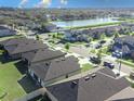 Neighborhood aerial view showcasing lush landscapes and a scenic lake, with well-maintained single Gathering homes at 1107 Brenton Leaf Dr, Ruskin, FL 33570