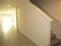 Bright hallway features tile flooring, leading to the living area and stairs to the second floor at 12178 Lily Magnolia Ln, Riverview, FL 33569
