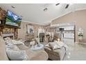 Bright living room features a fireplace, tile floors, plush seating, and an open layout with the kitchen at 12256 Katherwood St, Spring Hill, FL 34608