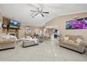 Bright living room features a fireplace, tile floors, plush seating, and an open layout with the kitchen at 12256 Katherwood St, Spring Hill, FL 34608