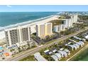 Stunning aerial view of oceanfront condos, showcasing its prime beach access and nearby waterway at 1270 Gulf Blvd # 905, Clearwater Beach, FL 33767