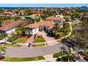 Beautiful home with a circular driveway, manicured lawn, and vibrant landscaping in a desirable neighborhood at 1314 Jumana Loop, Apollo Beach, FL 33572