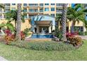 Beautiful entrance with a fountain, lovely landscaping, and inviting access to the building at 140 Riviera Dunes Way # 404, Palmetto, FL 34221