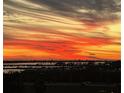 Beautiful sunset view overlooking the bay and city skyline, creating a peaceful and serene atmosphere at 140 Riviera Dunes Way # 404, Palmetto, FL 34221