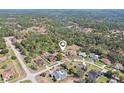 Aerial view of a neighborhood surrounded by lush greenery, showcasing the home's ideal location at 14048 Bruni Dr, Spring Hill, FL 34609