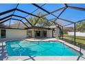 Inviting screened-in pool area featuring a sparkling pool and a spacious outdoor patio for relaxation at 14048 Bruni Dr, Spring Hill, FL 34609