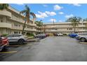 A view of the building's parking lot featuring ample space and access to the condo with a covered entryway at 2379 Finlandia Ln # 21, Clearwater, FL 33763
