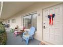Charming front porch with colorful chairs, decorative door, and a welcoming, cozy ambiance at 2379 Finlandia Ln # 21, Clearwater, FL 33763