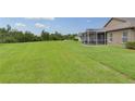 Large backyard features a screened lanai, providing a perfect outdoor living space at 30142 Sotogrande Loop, Wesley Chapel, FL 33543