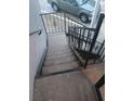 View of an exterior staircase with iron railings leading towards the parking area at 3801 N Oak Dr # A62, Tampa, FL 33611