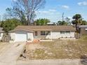 Single-story home featuring an attached garage and a cozy, inviting entrance at 4209 Westwood Dr, Holiday, FL 34691