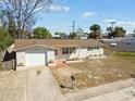 Single-story home featuring an attached garage and a cozy, inviting entrance at 4209 Westwood Dr, Holiday, FL 34691