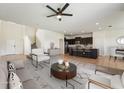Open-concept living room flows into kitchen with seating and neutral decor; bright and inviting space at 5955 Sweet Birch Dr, Riverview, FL 33578