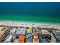Aerial view of beachfront home showcasing its location with parking, beach access, and ocean views at 614 Gulf Blvd # 4, Indian Rocks Beach, FL 33785