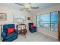 Cozy living room featuring comfortable seating, beach decor, and scenic ocean views through large windows at 614 Gulf Blvd # 4, Indian Rocks Beach, FL 33785