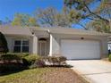 Charming single-story home featuring a 2-car garage and manicured landscaping at 8530 Alexandra Arbor Ln, Temple Terrace, FL 33637