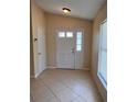 A tiled foyer features a six paneled door and neutral paint at 10102 Cedar Dune Dr, Tampa, FL 33624