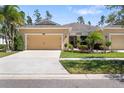Inviting single-Gathering home featuring a two-car garage and lush, manicured front lawn at 11714 Wrought Pine Loop, Riverview, FL 33569