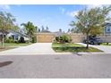 Well-maintained house exterior with double car garage and mature landscaping and street view at 11714 Wrought Pine Loop, Riverview, FL 33569